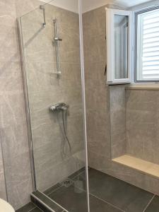 a shower with a glass door in a bathroom at guesthouse Libertas 1 in Dubrovnik +21 photos