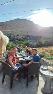a group of people sitting at tables eating food at Dana historic village in Dana