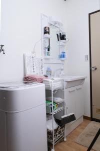 Una cocina con encimera blanca y refrigerador. en Housegreen, en Tokio 32 fotos más
