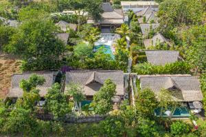 an aerial view of a house with trees at Gypsea Bali in Uluwatu