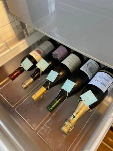 a group of wine bottles in a refrigerator at Vacation house月yue in Tokushima