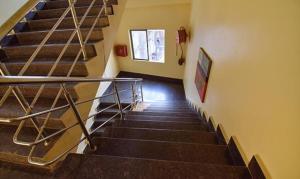 a staircase with a metal railing in a building at FabHotel RR Suites Guwahati in Guwahati