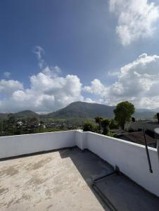 a balcony with a view of a mountain at Tailors Cottage in Hatton