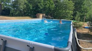 a woman is in a swimming pool at POLA in Łupawsko