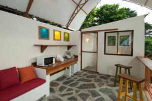 a tiny house with a kitchen and a living room at The Cloud Forest Magical Villa in Monteverde Costa Rica