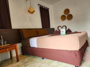 a bedroom with a bed with a monkey head on it at Tiki Beach Koh Phangan in Ban Tai