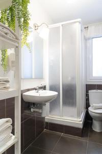 a bathroom with a shower and a sink and a toilet at At rueda Lopez in Almería