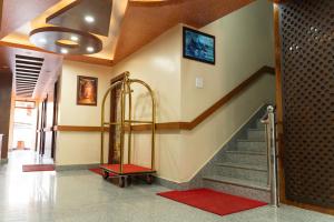 a hallway with a staircase with a red rug at Hotel Janmabhumi in Pashupatināth