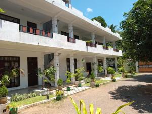 an external view of a building with potted plants at Airport Grand Holiday Home in Katunayake