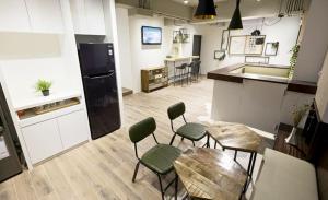 a kitchen with four chairs and a table and a counter at 109台北旅館-台北109青旅 109 Taipei Hotel - Taipei 109 Hostel in Taipei