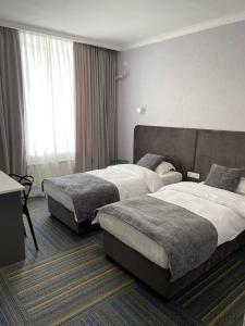 מיטה או מיטות בחדר ב-Жемчужина гостиница Балхаш
