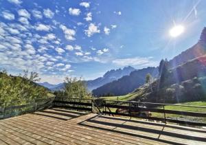 a bench on top of a mountain with the sun in the sky at Camp Suisse @ The Télécabine in Les Crosets