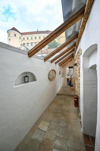 a hallway of a white building with a window at Boutique Apartman Mikulov in Mikulov