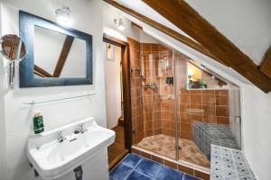 a bathroom with a sink and a shower at Boutique Apartman Mikulov in Mikulov