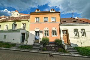a large house with stairs in front of it at Boutique Apartman Mikulov in Mikulov