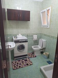 a bathroom with a washing machine and a toilet at Peaceful Beach in Ain Sokhna