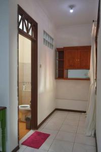 ein Zimmer mit einem Badezimmer mit Toilette und einem Durchgang in der Unterkunft Kuca Dago IV in Bandung