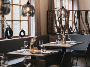 two tables in a restaurant with glasses on them at VAYA Pfunds in Pfunds