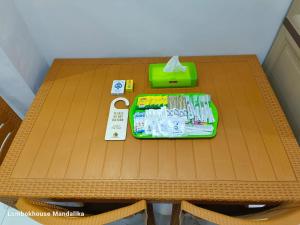 a table with a tray of toothpaste and a box on it at Lombokhouse Mandalika in Kuta Lombok