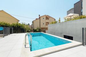 a swimming pool in the backyard of a house at Fides Stylish Apartments Tivat with Pool in Tivat