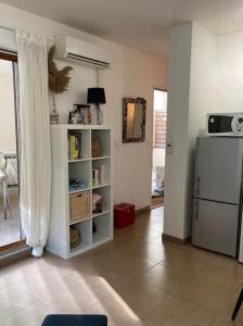 a living room with a refrigerator and a tiled floor at Appartement centre ville avec Clim/terrasse/garage in Marseille