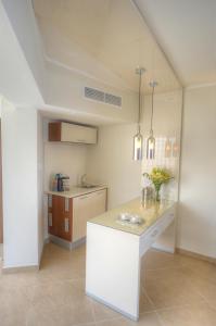 a kitchen with a white island in a room at The Preluna Hotel in Sliema