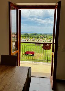 a room with a table and a view of a balcony at Appartamento La Rondine in Pignataro Maggiore
