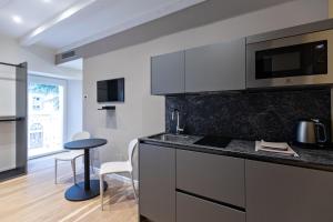 a kitchen with a sink and a counter top at Palazzo 7 Centro Storico NO Pet Friendly Apartment in Domodossola