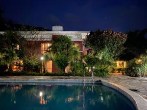 a house with a swimming pool at night at Initial Cold Lodge in Burhānilkantha