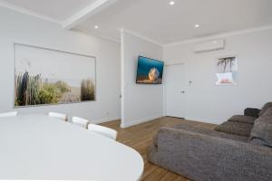 a living room with a couch and a living room with a couch at 22 Cooyou Close in Exmouth