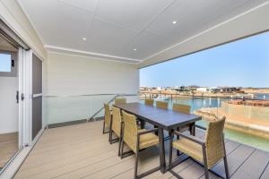a dining room with a table and chairs on a balcony at 22 Cooyou Close in Exmouth