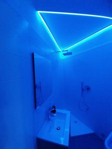 a white bathroom with a blue light on the ceiling at Petit Bijou - Cervinia - BOX AUTO - CIR 0151 in Breuil-Cervinia