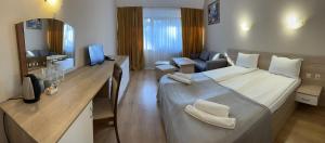 a hotel room with a large bed and a desk at Room in BB - Hotel Moura Double Room in Borovets