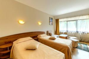 a hotel room with two beds and a window at Room in BB - Hotel Moura Double Room in Borovets