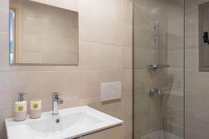 een badkamer met een wastafel en een douche bij Voula's Secret Garden Studio in Athene