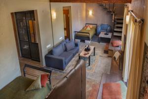 an overhead view of a living room with a couch and chairs at Tufenkian Avan Marak Tsapatagh Hotel in Kzylkʼend