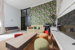 a living room with a ping pong table and chairs at RedDoorz at Kandaga 80 near Stadium Arcamanik in Bandung