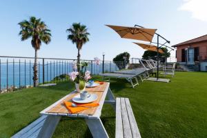 a picnic table with a view of the ocean at Villa Matilde in Sanremo