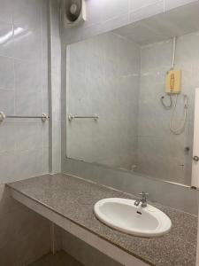 La salle de bains est pourvue d'un lavabo et d'un miroir. dans l'établissement รีสอร์ท สุพรรณ, à Suphanburi