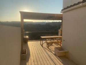 a deck with a picnic table and the sun setting at Ca la Francesa in Juncosa +14 photos