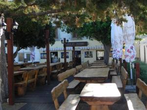 a row of tables and chairs in front of a restaurant at Apartments Riva in Pag
