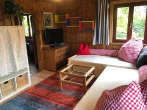 a living room with a couch and a tv at Villa Alberto - gemütliches Häuschen in Ötztal-Bahnhof