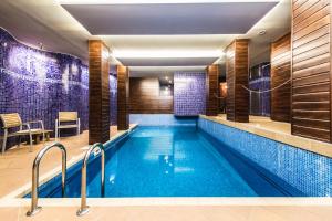 a swimming pool in a hotel with a restaurant at Boutique Hotel Bristol in Košice