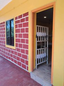 a brick wall with a door and a window at Trippr Gokarna - Beach Hostel in Gokarna