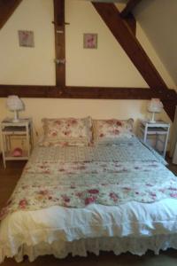 a bedroom with a large bed with flowers on it at La Roche Bellevue in Luynes