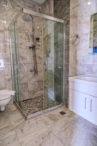 a bathroom with a shower and a toilet and a sink at MARİN YALIKAVAK in Bodrum City