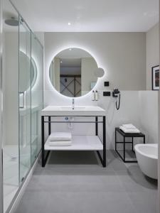 a bathroom with a sink and a mirror at RMH Modena Raffaello in Modena