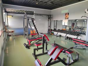 a gym with several tread machines in a room at Grand Avenue Hotel in Tashkent