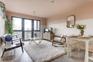 een woonkamer met een tafel en stoelen bij Large river view room in Londen