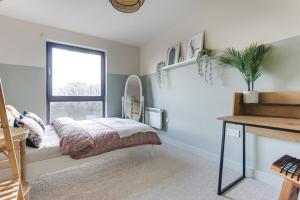a bedroom with a bed and a window at Large river view room in London